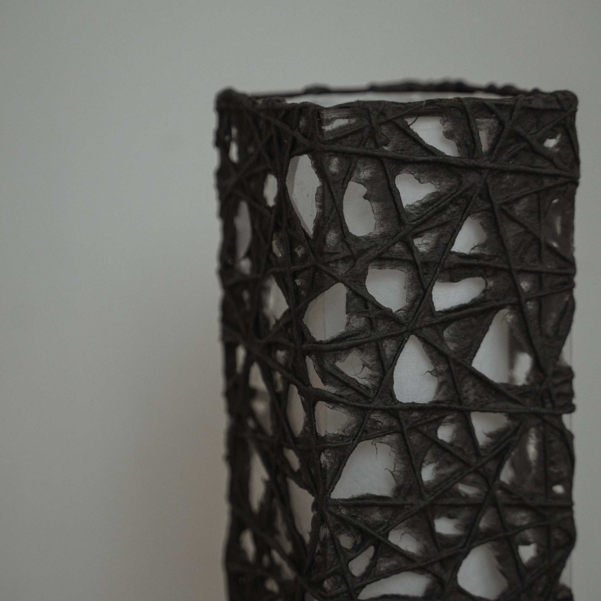 Detail of black Me-look paper texture showing web like Kozo fibers entwined on the Me Look 02 lamp shade.
