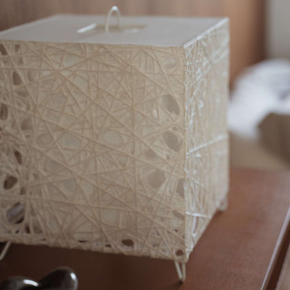 Close up view of the white Melook washi paper texture with intricate spiderweb like fiber patterns on the cube lamp.