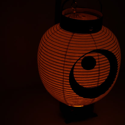 A moon and star chochin lantern glowing warmly against a black background suitable for a bedside or desk lamp.