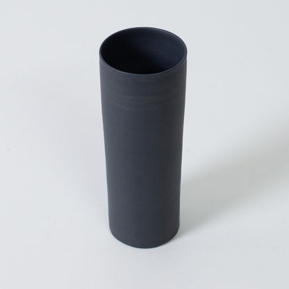 A top view of a cylindrical black single flower vase made from authentic Banko yaki clay for modern interiors.