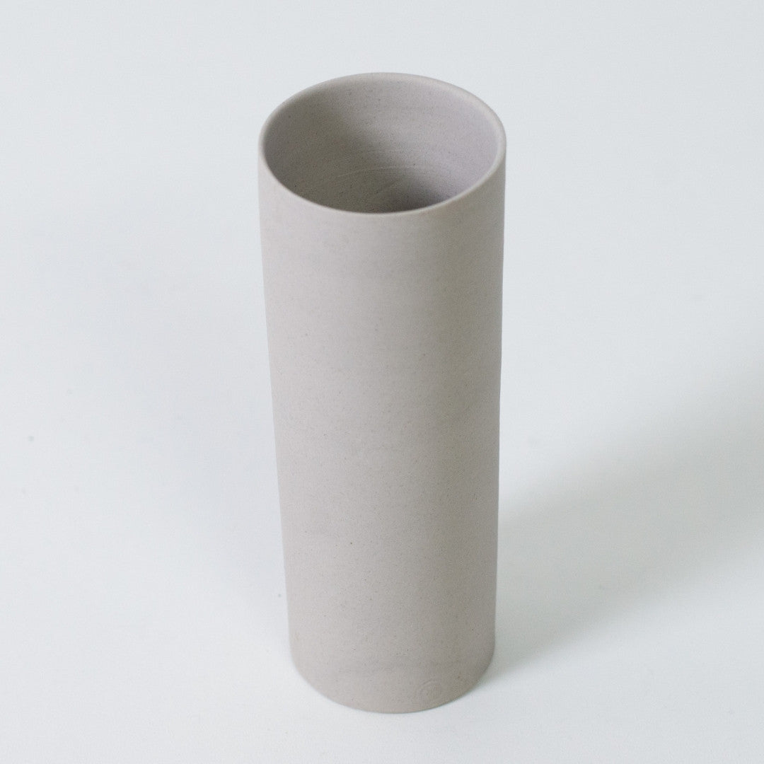 Top perspective of a white cylindrical single flower vase handcrafted by Nankei Pottery from Banko yaki clay.