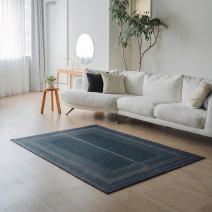 Japanese Tatami Area Rug "Ranks" Indigo Navy on a light wooden floor in a modern living room for daily mindful relaxation.