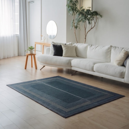 Japanese Tatami Area Rug "Ranks" Indigo Navy on a light wooden floor in a modern living room for daily mindful relaxation.