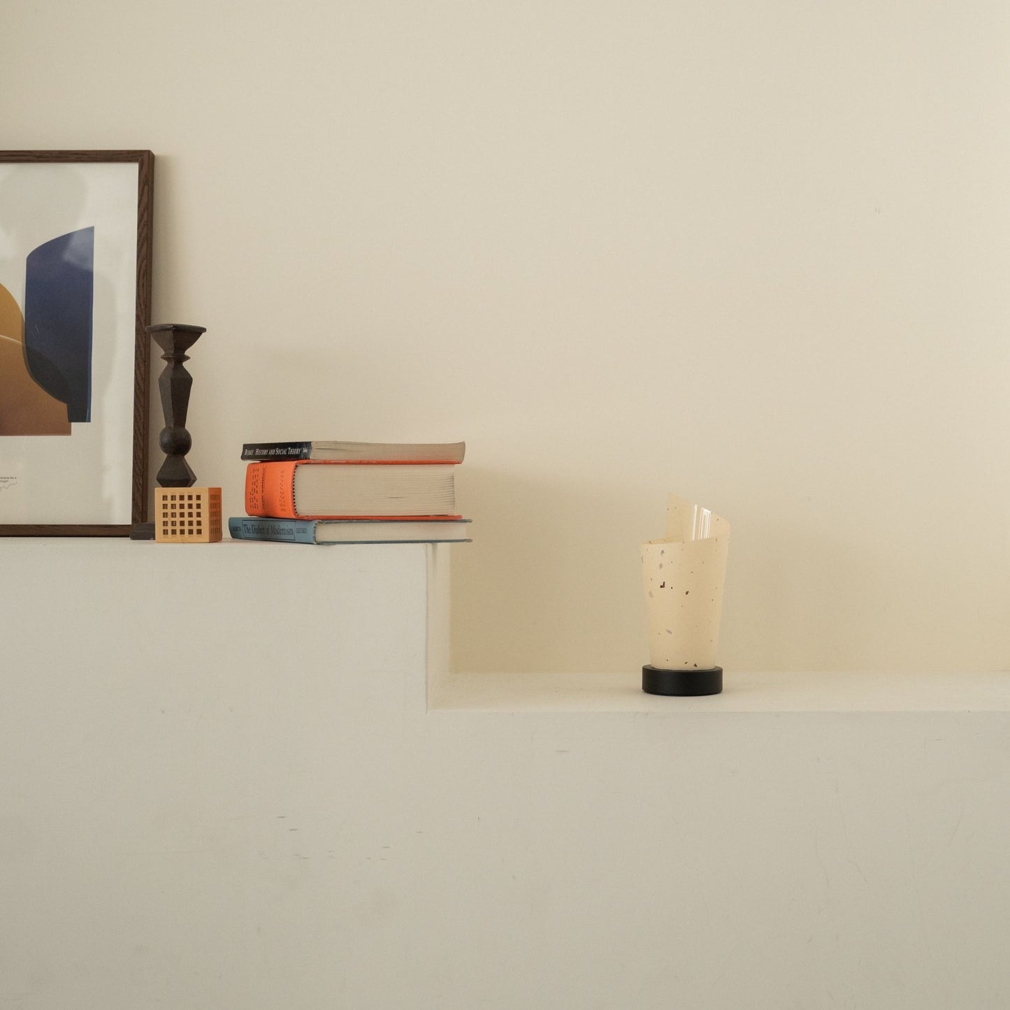 Unlit Japanese paper table lamp "Maki" with rustic flecks on a white console table in a Japandi living room.