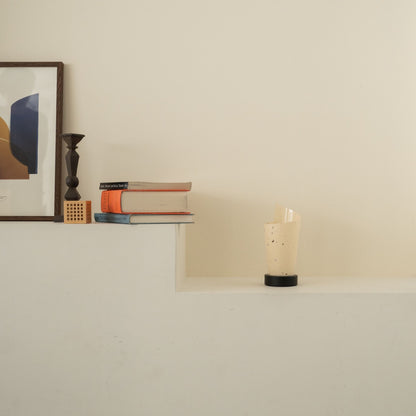 Unlit Japanese paper table lamp "Maki" with rustic flecks on a white console table in a Japandi living room.