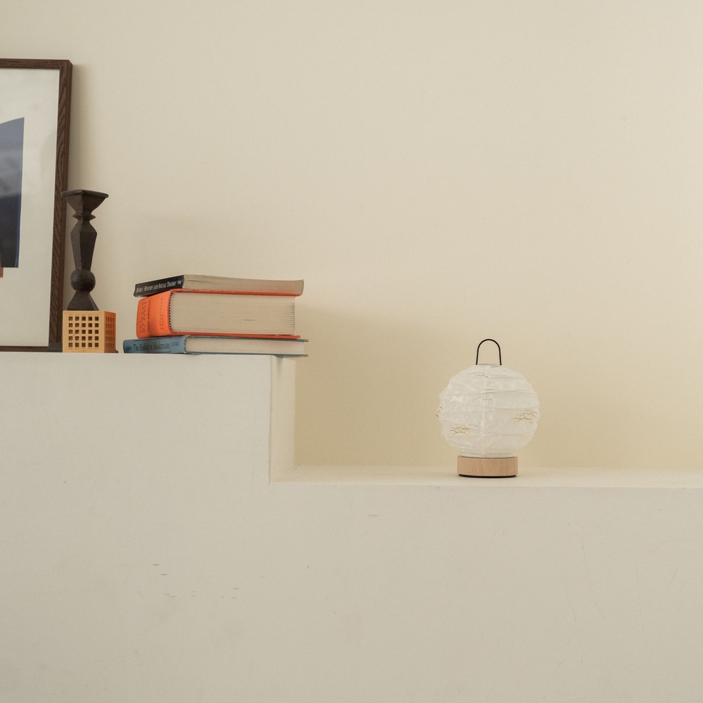 Unlit round Japanese paper table lamp "Yuhi" Rabbit placed on a white console table in a minimalist Japandi living room.