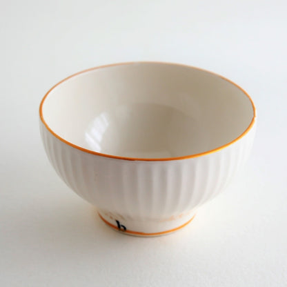 An elegant white porcelain matcha bowl from Buzan Kiln, highlighting minimalist Japanese design, gentle curves, and the distinctive glaze of Mino Ware pottery.
